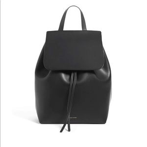 Black leather backpack, with red interior.